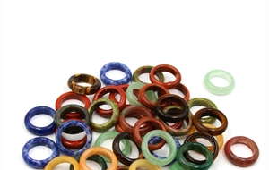 Polished natural stone rings featuring tiger eye, agate, and aventurine textures