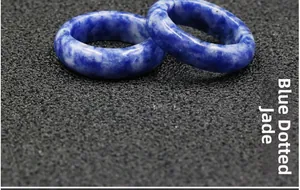 Detailed macro view of two natural blue point jade stone rings with marble textures