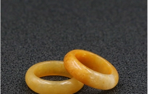 Macro shot of two polished yellow topaz rings showcasing smooth texture and translucency