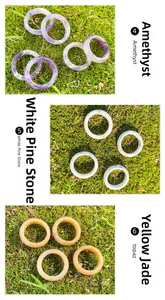 Detailed view of natural amethyst, white turquoise, and topaz stone ring bands on moss