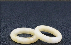 Detail of two polished light yellow natural stone rings with a smooth translucent finish