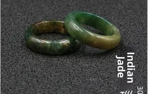 Detailed close-up of two polished Indian Agate rings showcasing natural green patterns
