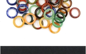 Flat round natural stone rings in various colors including agate and tiger eye stones