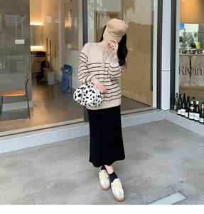 Detail of cute dalmatian print plush crossbody bag with casual striped sweater outfit