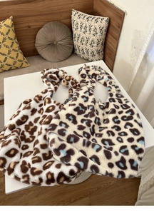 Close-up of two large leopard print plush tote bags in brown and blue grey colors