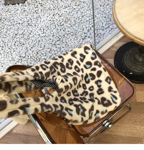 Close-up of leopard plush tote bag featuring soft faux fur and plaid lining detail
