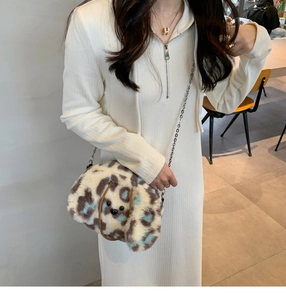 Close-up of leopard print plush dog-shaped handbag with premium metal chain strap