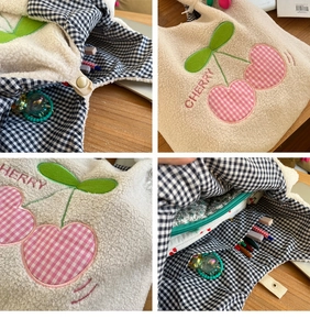 Detail of plush lamb wool tote bag showing cherry embroidery and interior pocket layout