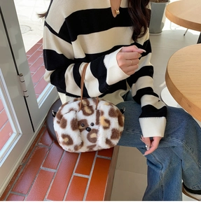 Close-up of fluffy puppy handbag with leopard print faux fur and leather strap