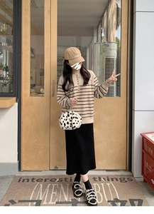 Chic Dalmatian print plush handbag paired with a beige striped knit sweater and long skirt