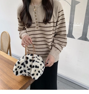 Close-up of plush puppy tote bag with black polka dots and dimensional ear details
