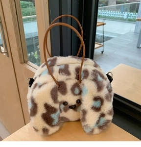 Close-up of plush puppy handbag featuring leopard print pattern and faux fur texture