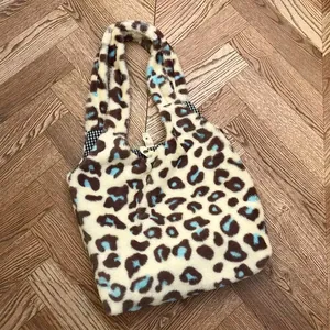 Large plush leopard print tote bag with soft faux fur and magnetic snap closure