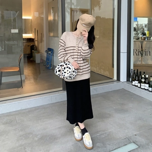 Cute plush dalmatian print handbag styled with casual autumn knitwear and long black skirt