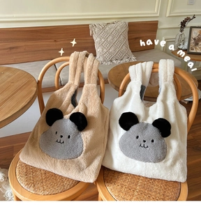 Detail of plush faux fur tote bags with cute animal design and checkered handle lining