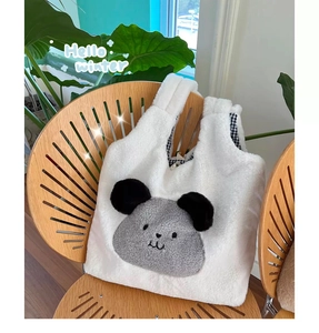 Close-up of fluffy faux rabbit fur tote with cute bear face and checkered lining