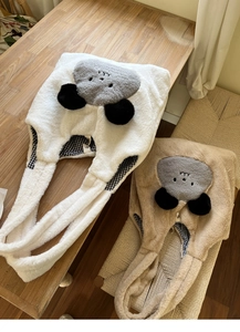 Detail of plush animal tote bag featuring soft faux fur and plaid lining on wooden bench