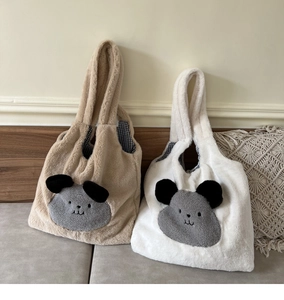 Detailed view of plush tote bags with cute animal embroidery and checkered lining