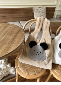 Detail of soft khaki faux rabbit fur tote bag featuring a cute grey cartoon animal face
