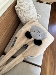 Detail of cute plush tote bag showing soft faux rabbit fur and checkered fabric lining