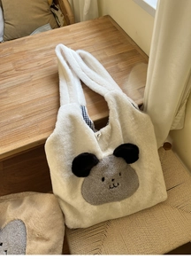 Detail of soft white plush tote bag with cartoon dog patch and checkered lining
