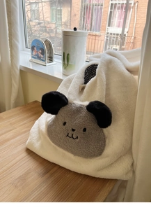 Close-up of fluffy faux fur tote bag showing plush cartoon ears and checkered lining detail
