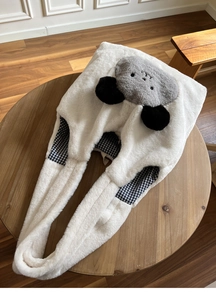 Detail of white plush animal hood scarf with cute ears and checkered cotton lining