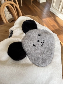 Detail of soft plush tote bag featuring a cute koala face with black and white plaid lining