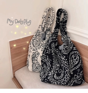 Detail of plush lamb wool paisley tote bags with soft texture and boho ethnic patterns