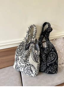 Detail of plush paisley tote bag with fluffy texture and black and white checkered lining