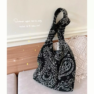 Large paisley pattern lamb wool tote bag in black and white with a soft fuzzy texture