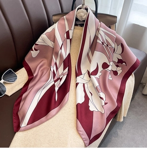 Detail of luxury silk square scarf with floral patterns on a chic lifestyle background