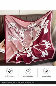 Detail of luxury silk square scarf with white iris floral print and soft burgundy fabric