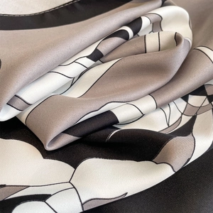 Macro shot of 90cm square silk scarf showing high-quality twill weave texture and patterns
