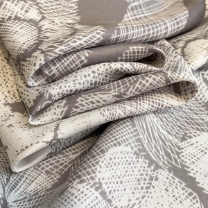 Macro shot of silk scarf showing detailed floral print and fine twill weave texture