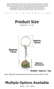 Detailed macro view of Unakite crystal skull keychain with silver metal ring and chain