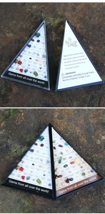Macro detail of 36 natural mineral stone specimens set in a triangular display box