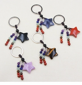 Detail of star-shaped crystal keychains with colorful stone beads and braided cords