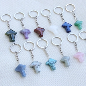 Natural crystal mushroom keychains in various gemstones like amethyst and aventurine