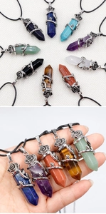 Macro view of crystal hexagonal point pendants with vintage silver rose metal wrapping