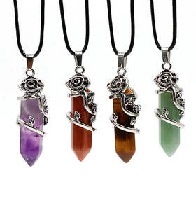 Detail of rose-adorned hexagonal crystal pendants in multiple colors with black cords