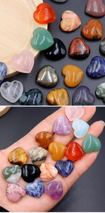 Close-up of polished 20mm heart-shaped natural crystal stones in various vibrant colors