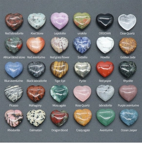 Flat lay of 30 assorted 20mm heart-shaped polished natural crystals and healing stones