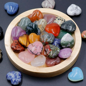 Polished 20mm heart-shaped natural crystal and agate stones in a wooden tray