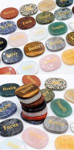 Macro detail of natural engraved stones with gold lettering like Harmony and Strength