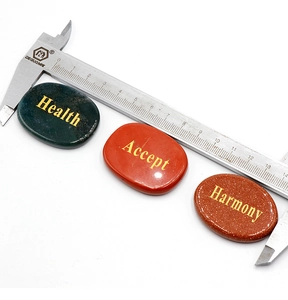 Three engraved natural stones showing size measurement of 14cm with a caliper