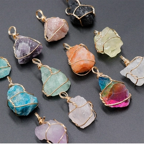 Macro view showing a variety of colorful wire wrapped natural crystal stone pendants