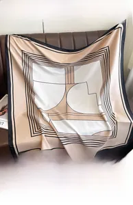 Detailed view of luxury geometric print silk scarf in soft twill fabric on leather