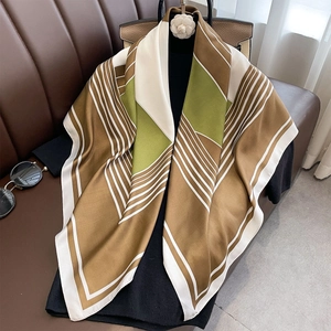 Elegant 90cm geometric silk-touch scarf draped on a black top with luxury accessories