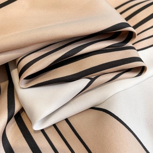 Elegant 90cm printed square scarf featuring beige and black geometric twill silk texture